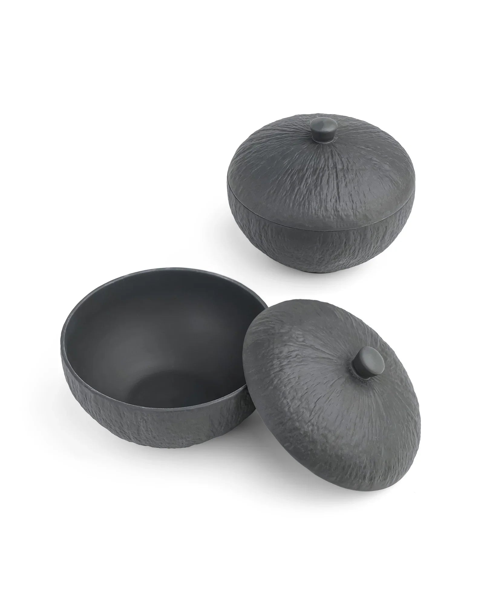 Textured black porcelain serving bowls with lids from Vola Global on white background